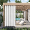 White waterproof outdoor curtain with grommet top hanging in a wooden pergola structure.