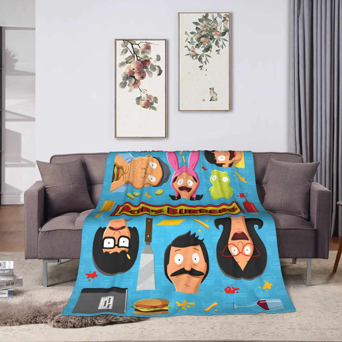 A blue throw blanket featuring various anime and funny themed characters like a bear, a cat, and a man's face.