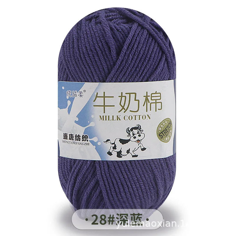 A skein of purple milk cotton yarn with a label featuring Chinese and English text.