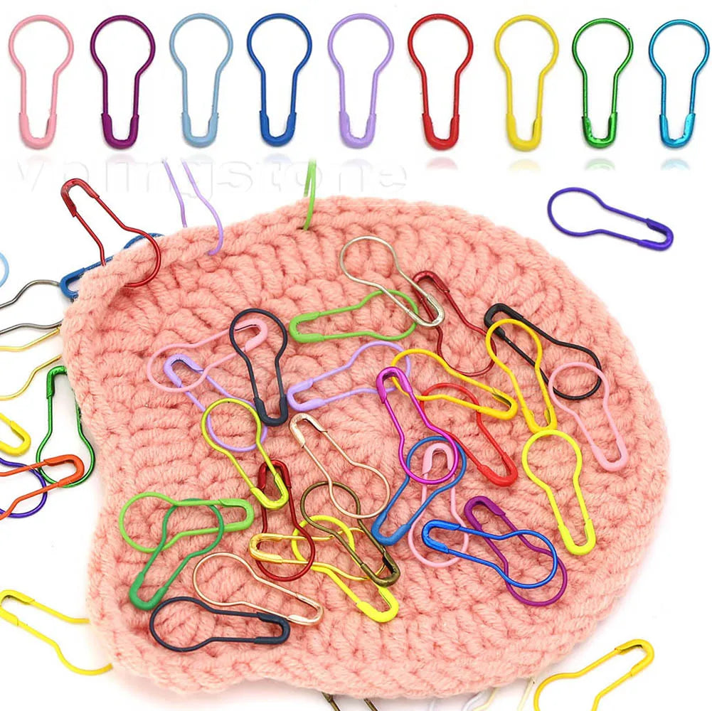 A collection of gourd-shaped locking safety pins in various colors and sizes for knitting and sewing.