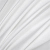 Soft white luxury bamboo flat sheets draped in flowing fabric.