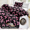Black duvet cover set with pink plaid bow print and matching pillowcases displayed on a bed.
