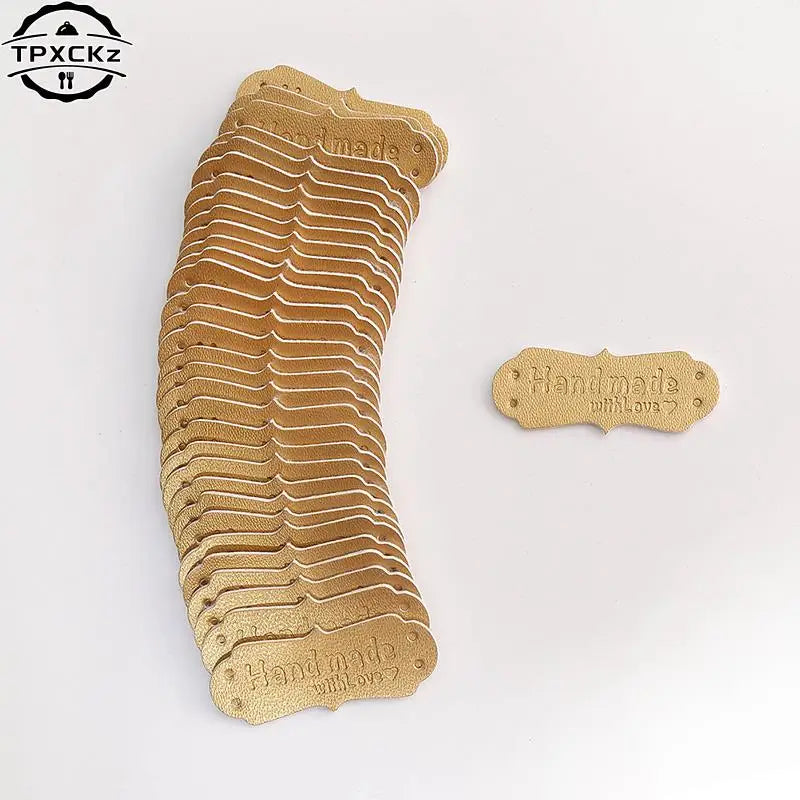 A stack of 50 PU leather embossed tags in a tan color for handmade crafting.
