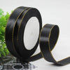 Roll of black satin ribbon with gold edge for gift wrapping and crafts