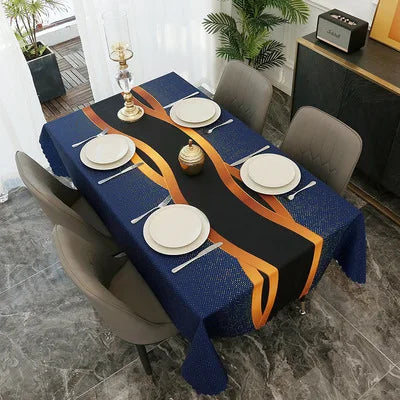 A dark blue rectangular tablecloth set for dining or party decor featuring gold and orange accents.