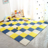 A yellow and blue interlocking foam play mat with a diamond pattern featuring various colorful toys on a light floor.