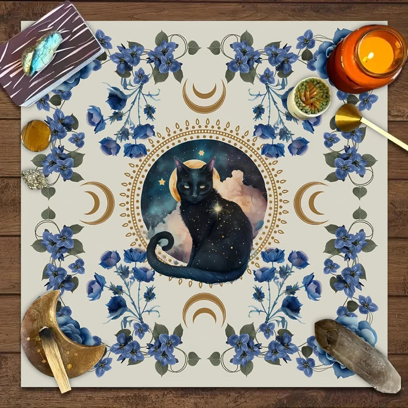 A floral tarot card mat featuring a silhouette of a black cat against a moonlit background.