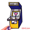 A colorful embroidered patch depicting a vintage game console with the text GAME ON on the top and a heart symbol on the scre