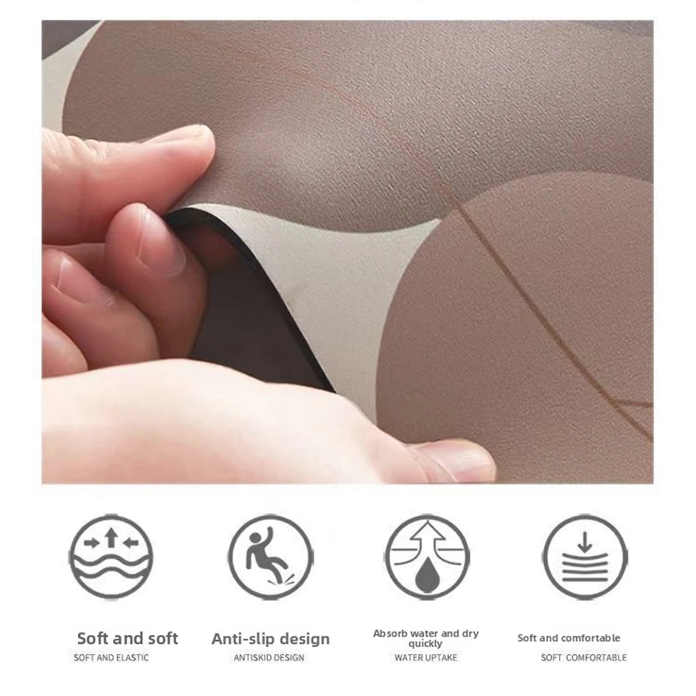 A hand is pressing a leaf-shaped bathroom mat with a rubber backing, showing its soft and anti-slip design.