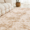 A light beige shaggy area rug in a soft plush texture placed on a light wooden floor.