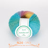A ball of multi-colored wool yarn with shades of blue, green, yellow, and purple.