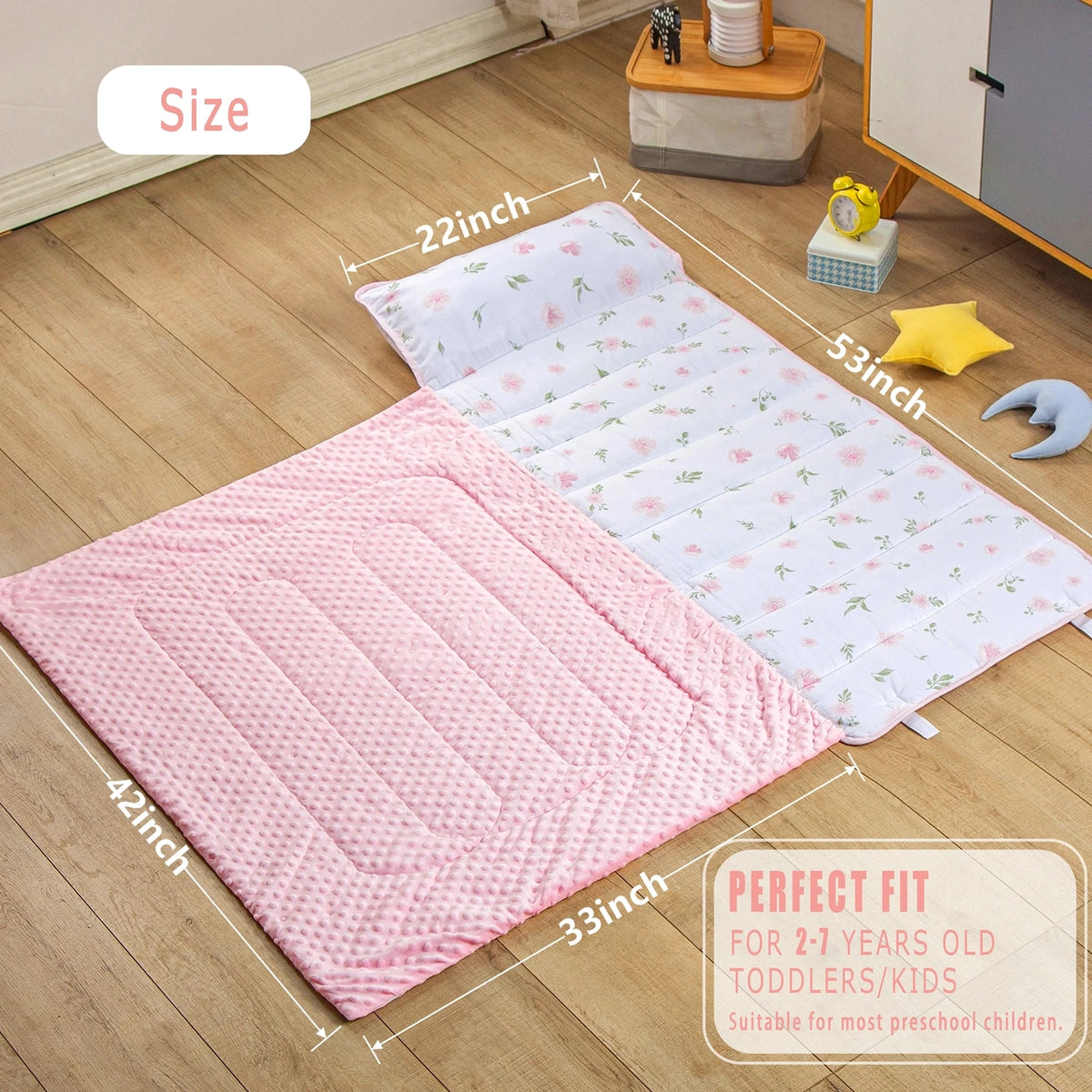 A pink quilted toddler nap mat set includes a blanket, pillow, and accompanying accessories for toddlers.