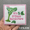 Pink embroidered patch with the text It's 5 o'clock Somewhere featuring a green tropical drink design