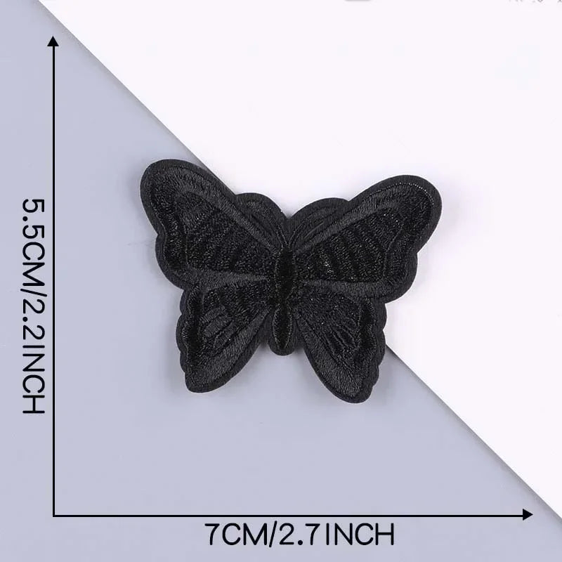 A black embroidered leather butterfly patch is shown against a gray background with dimension markings.