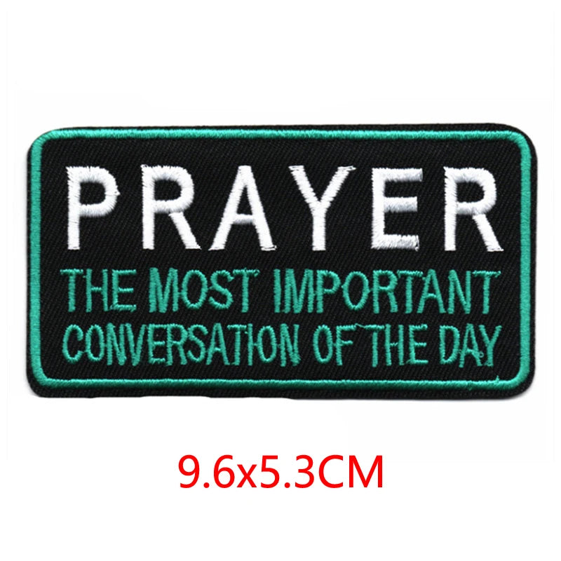 Black and teal embroidered letter patch with the text Prayer the most important conversation of the day