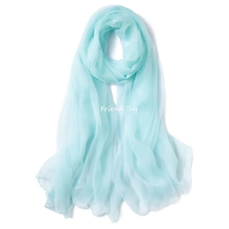 Light blue sheer scarf draped around a neck