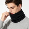 A man wearing a black soft cotton warm neck scarf over a gray sweater.