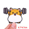 An embroidered patch of a fluffy orange and white cartoon dog face.