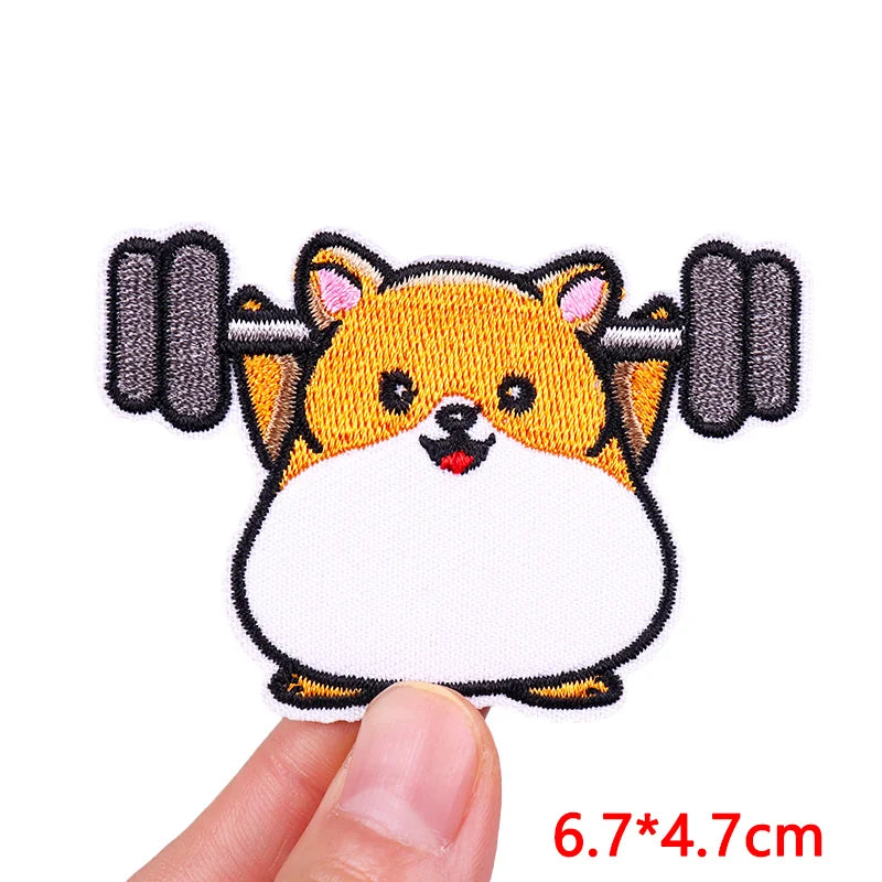 An embroidered patch of a fluffy orange and white cartoon dog face.