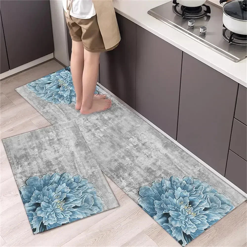 A set of two non-slip waterproof kitchen rugs with a diamond print placed on a light wood floor next to dark cabinets.
