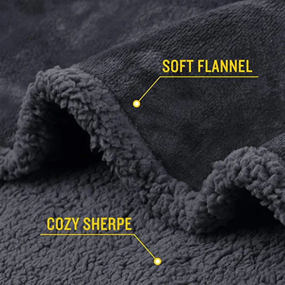 Close-up of a dark gray soft flannel fabric with cozy sherpa trim and yellow labels