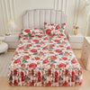 A floral ruffle bed skirt set featuring red and pink roses on a white background.
