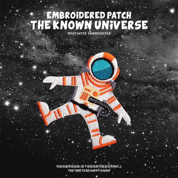 Embroidered patch featuring an astronaut figure in orange and white with a blue helmet against a starry background.