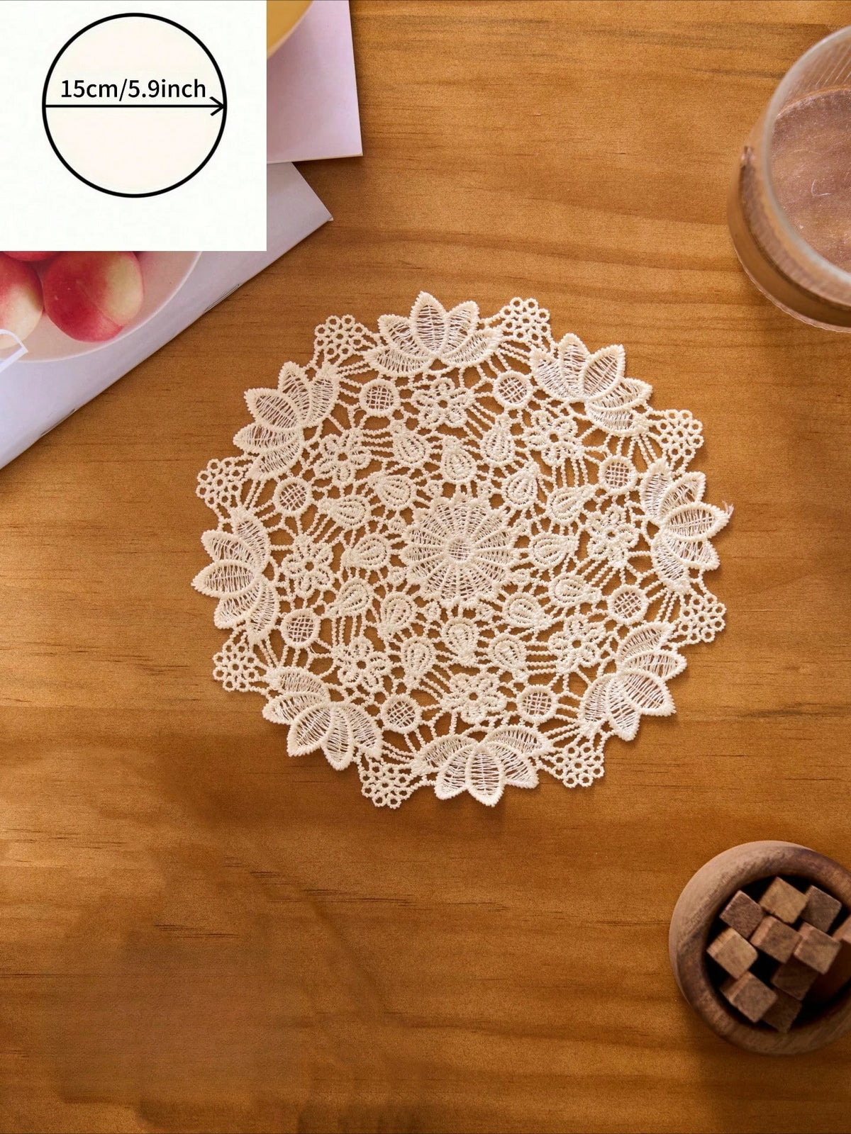 A white floral embroidered doily or placemat is centered on a wooden table, with a measuring line indicating 15cm/5.9inch.
