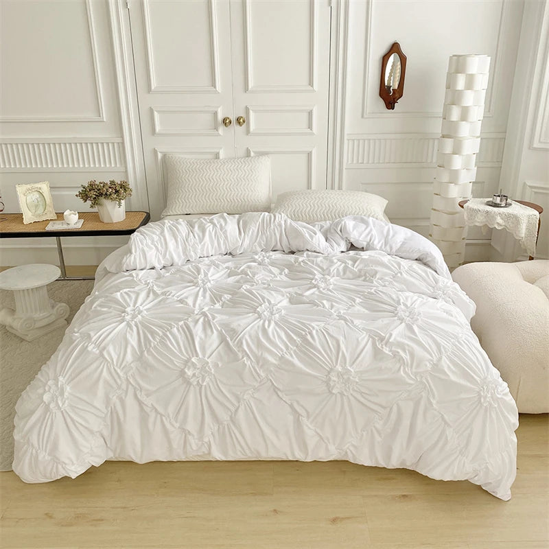 White quilted duvet cover set displayed on a bed with white molding and pillows.