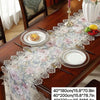 Elegant jacquard lace table runner displayed on a wooden table with place settings.