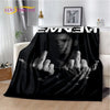 A black graphic throw blanket featuring a vintage-inspired image of a hand making the devil sign.