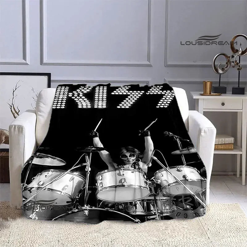 A black printed flannel travel blanket featuring a silhouette of a drummer playing a drum kit.