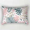 A decorative pillowcase featuring a tropical leaf print in shades of pink, green, and beige.
