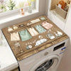 A vintage laundry appliance cover is displayed on a white washing machine, featuring decorative elements and a natural wood f