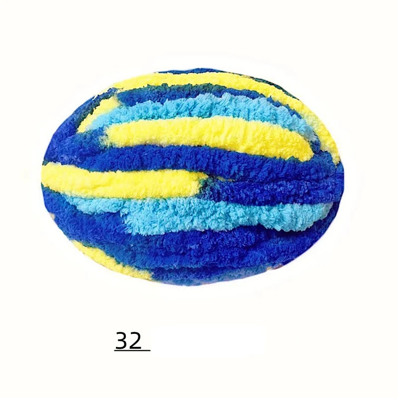 A round ball of blue and yellow fuzzy yarn with horizontal stripes.