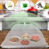A clear foldable mesh cover protecting fresh fruit and vegetables on a wooden surface.