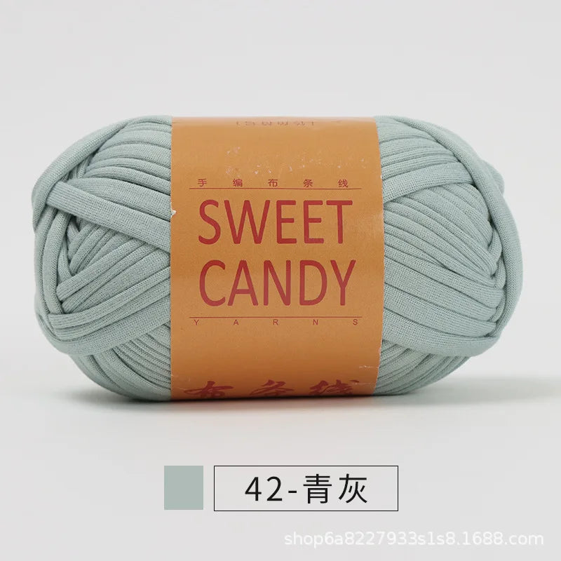 A ball of light mint green hand-dyed fabric strip yarn labeled Sweet Candy with Chinese characters.