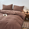 A brown plaid duvet cover set with matching pillows on a bed.