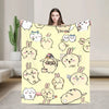 A yellow flannel throw blanket featuring a repeating pattern of cute Chiikawa cartoon characters.