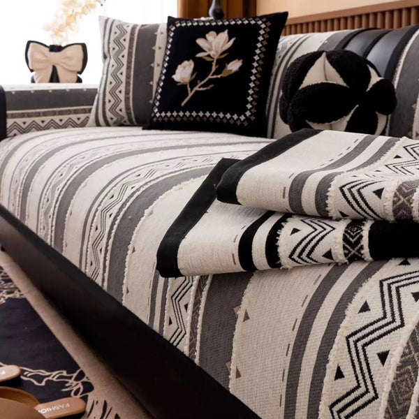 A close-up of a bohemian chenille sofa cushion cover featuring gray, black, and cream geometric patterns.