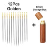 A set of 12 gold stainless steel self-threading sewing needles and a brown storage box