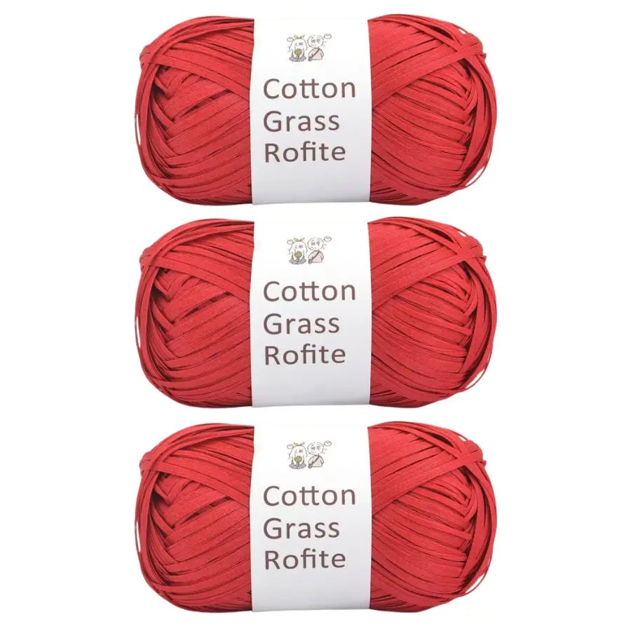 A set of red cotton grass roving yarn spools with white labels.