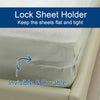 A close-up of a gray bedsheet corner with an invisible and durable lock sheet holder clip being used to keep the sheets flat 
