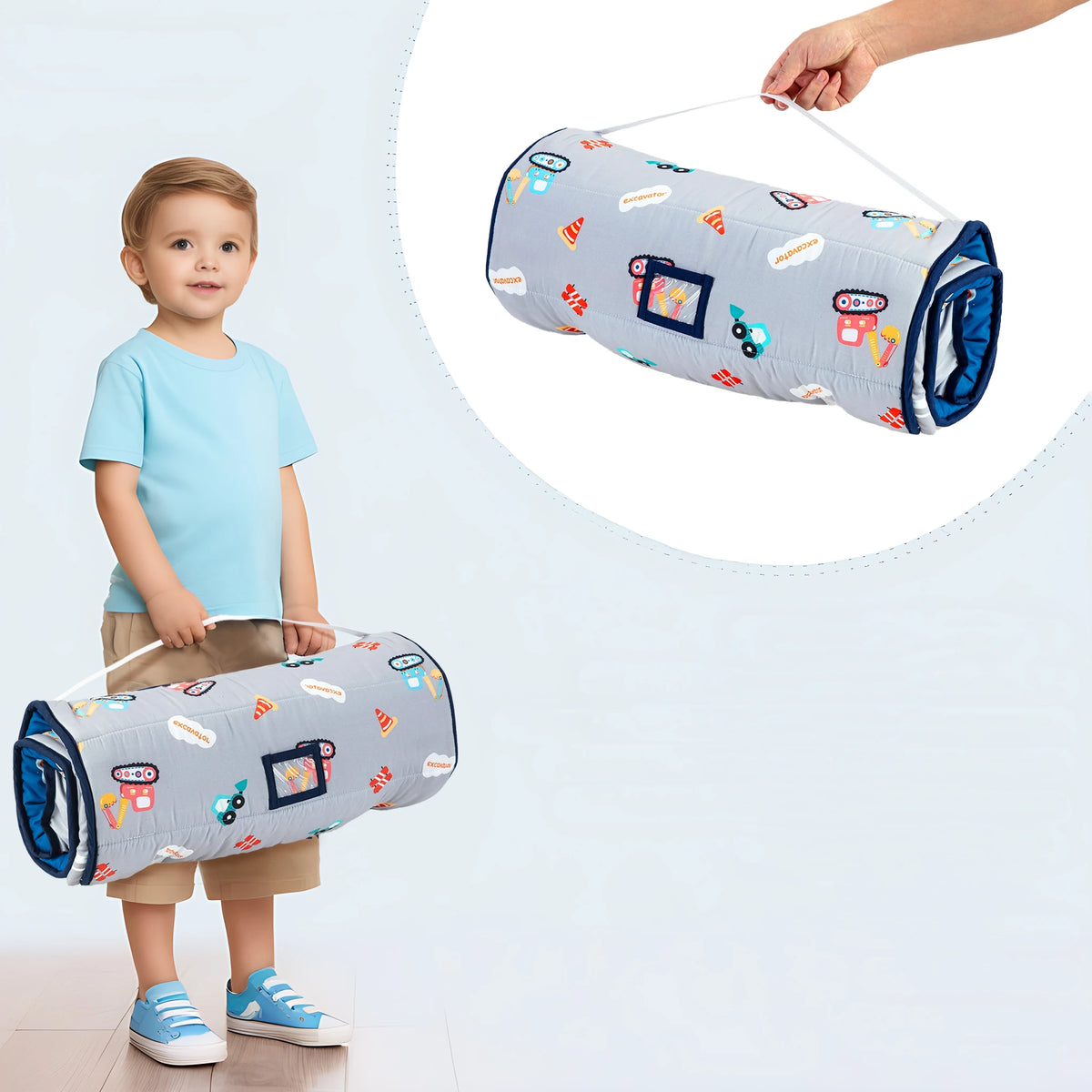 A toddler is holding a rolled-up gray and white nap mat with colorful decorations.