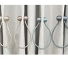 A set of two pearl-colored rope tieback hair accessories with decorative grips shown against a white curtain.
