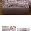 A pink floral bedding set featuring ruffled duvet covers and pillows.