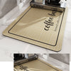 A beige silicone mat used as a multi-space application for draining coffee cups and brewing equipment.