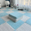 A light blue and white checkered floor mat with a textured blue cushion placed on it, near a window.
