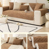 A brown plush sofa cushion cover with a quilted texture and cream accents shown on a modern sofa.