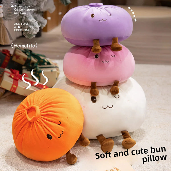 A display of soft and cute bun pillows in orange, pink, and white colors.